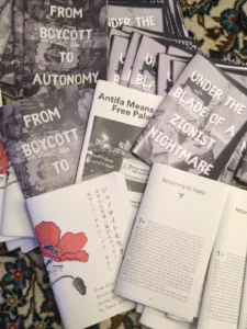 Slide 9: A pile of zines, including FROM BOYCOTT TO AUTONOMY, UNDER THE BLADE OF A ZIONIST NIGHTMARE, Antifa Means Free Palestine, Returning to Haifa, and From Gaza to Japan: Essays on Life during the Genocide by Mean Alhaj-Ali